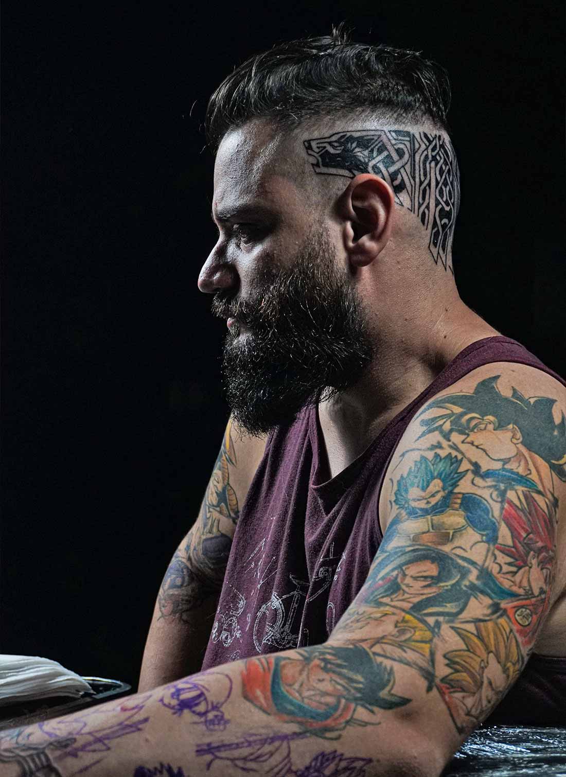 Person with Tattoos on Arms and back of Head Person with Tattoos on Arms and back of the Head